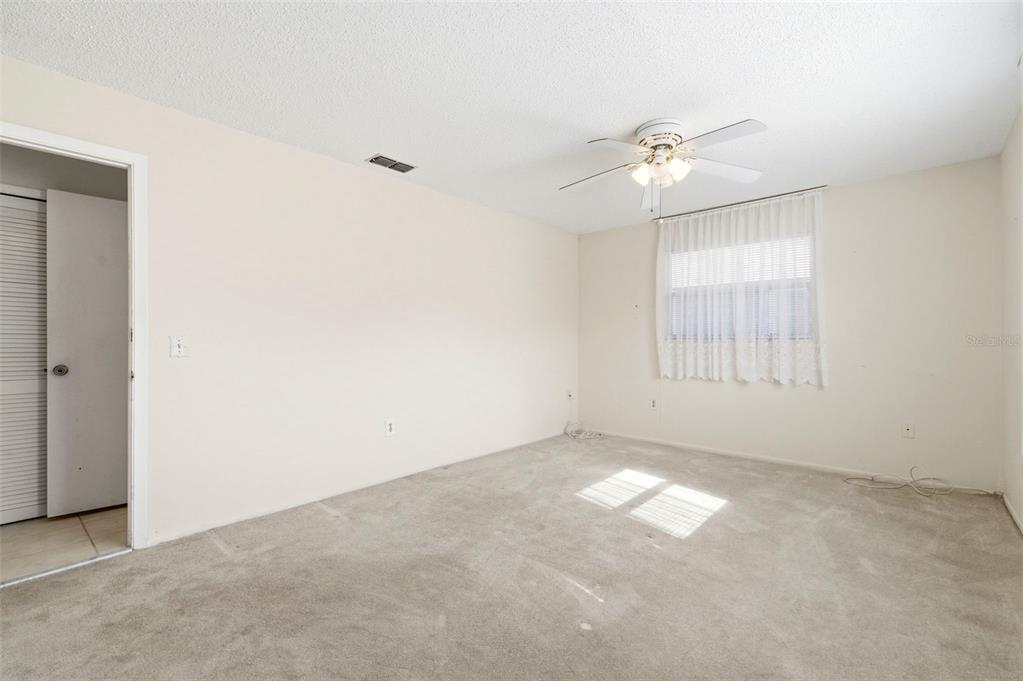 4101 Passport Lane, Unit 203 New Port Richey, FL 34653 - Photo 36 of 83 an empty room with windows and fan