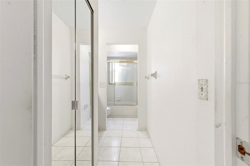 4101 Passport Lane, Unit 203 New Port Richey, FL 34653 - Photo 39 of 83 a bathroom with a glass shower door