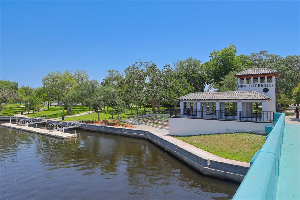 4101 Passport Lane, Unit 203 New Port Richey, FL 34653 - Photo 72 of 83 a view of a house with swimming pool next to a yard
