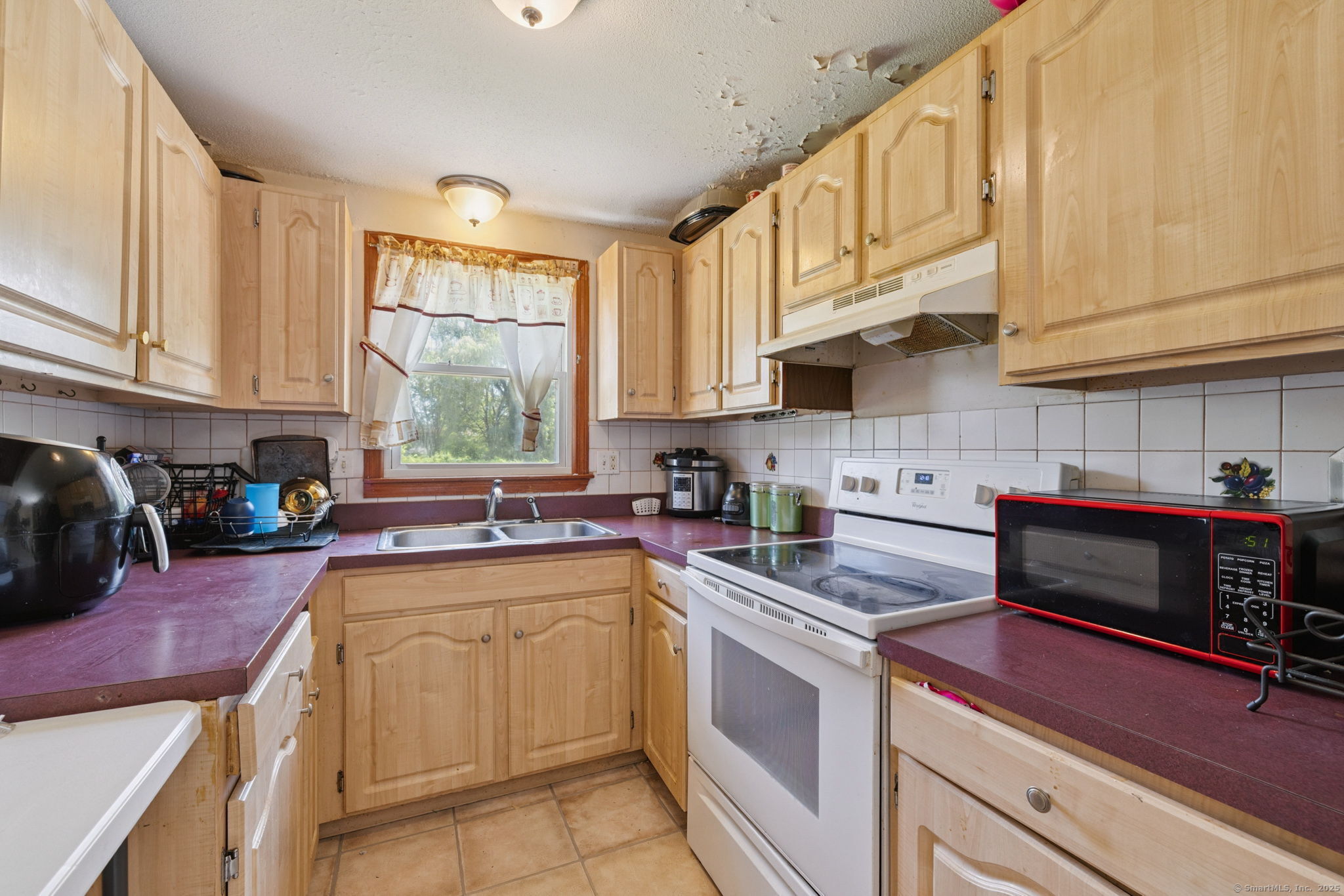 2 Sandra Drive Bloomfield, CT 06002 - Photo 19 of 32 a kitchen with stainless steel appliances granite countertop a sink a stove and cabinets