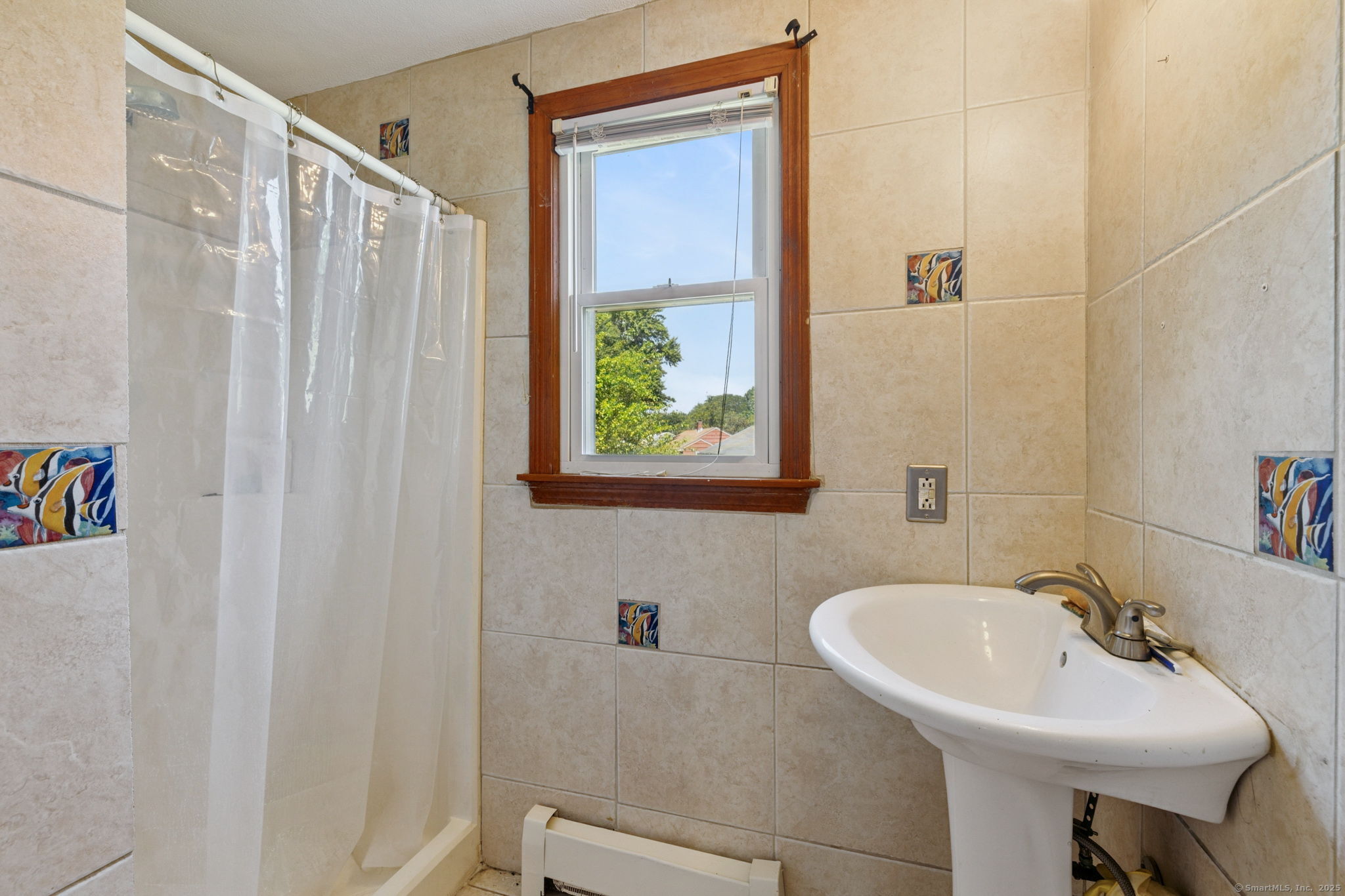 2 Sandra Drive Bloomfield, CT 06002 - Photo 22 of 32 a bathroom with a sink a toilet and a mirror