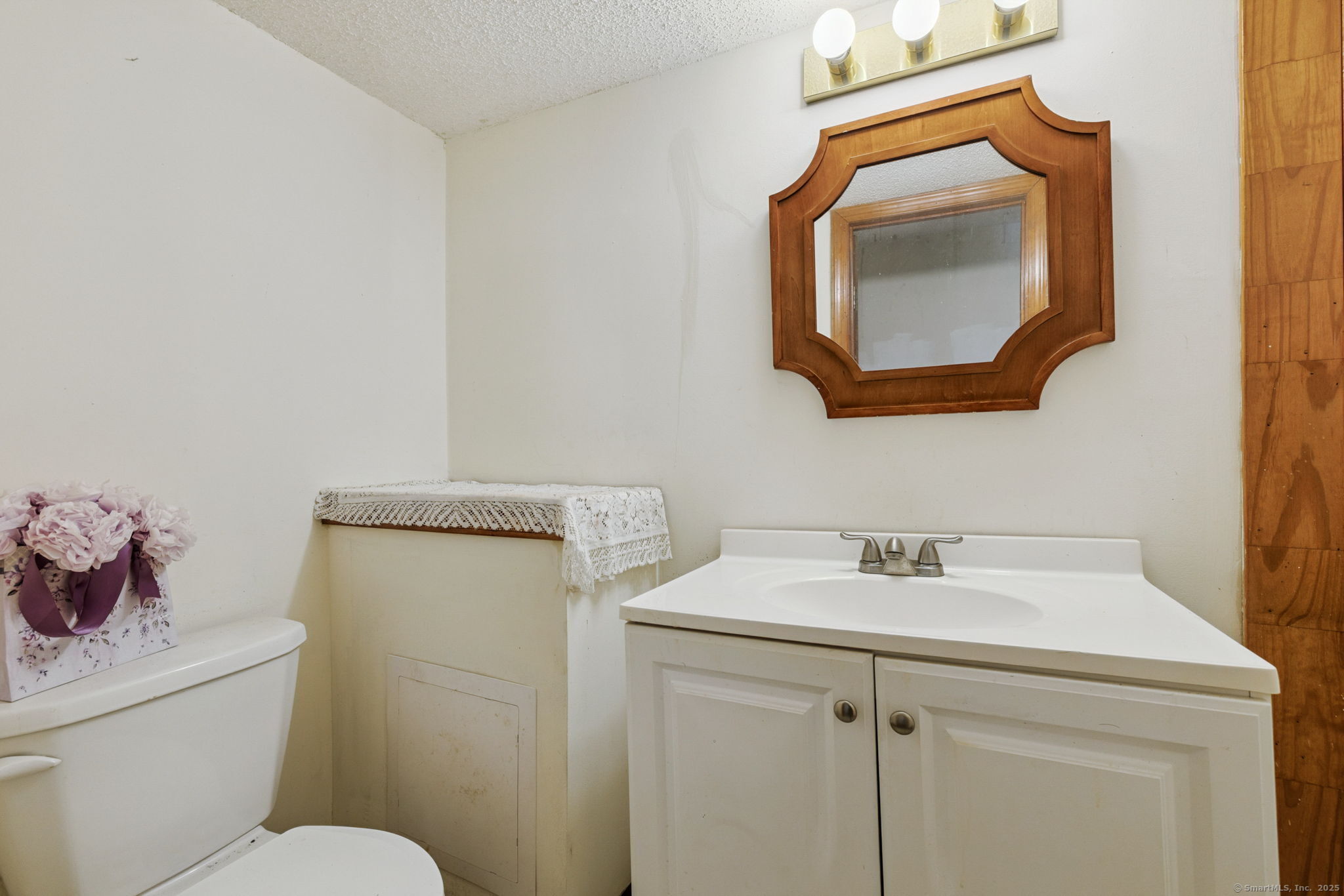 2 Sandra Drive Bloomfield, CT 06002 - Photo 29 of 32 a bathroom with a toilet sink vanity and mirror