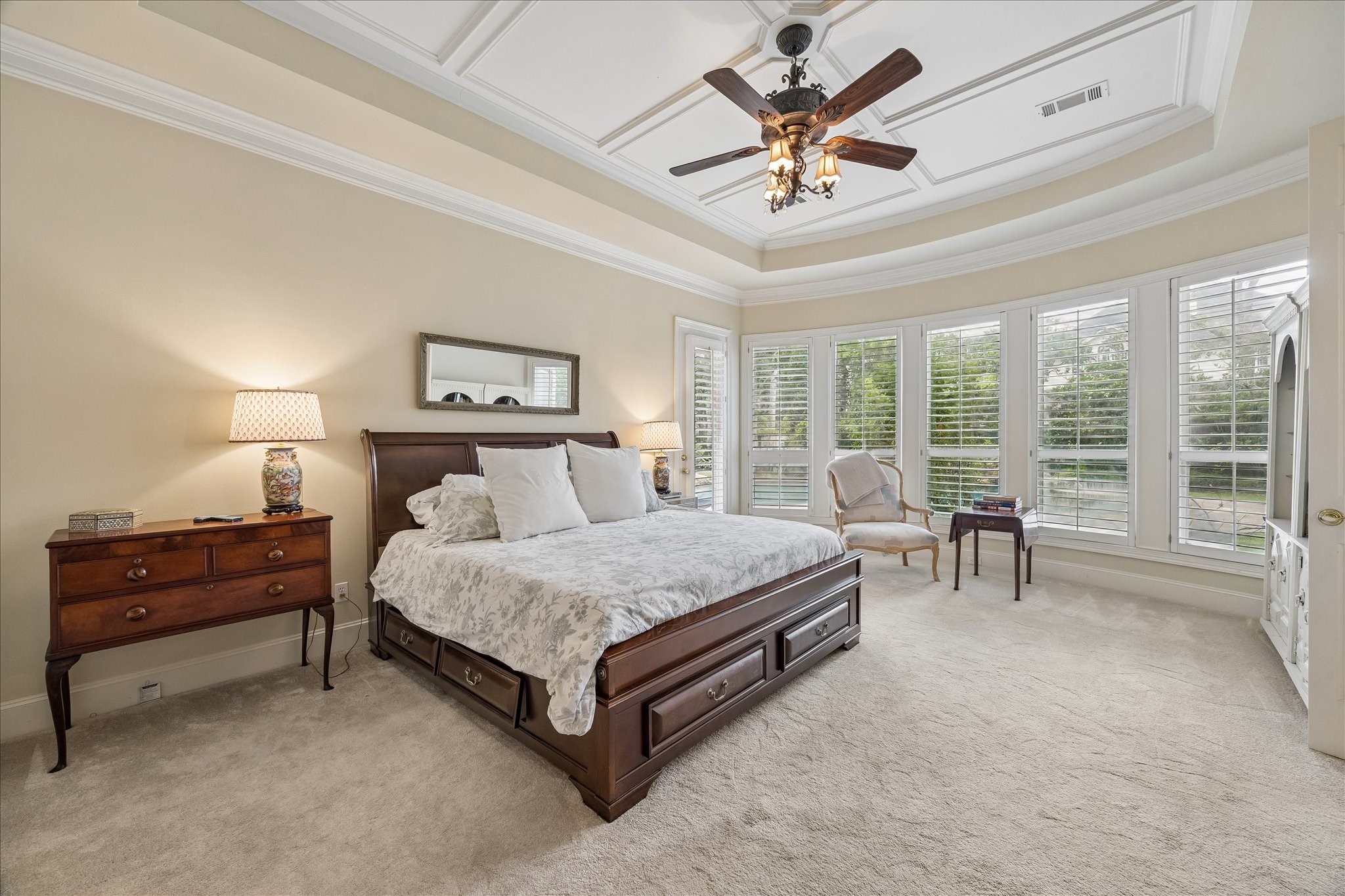 11421 Whippoorwill Road Houston, TX 77024 - Photo 14 of 33 The first floor primary suite has a double entry door, a tray ceiling, and plantation shutters over the bay windows that overlook the pool and backyard.