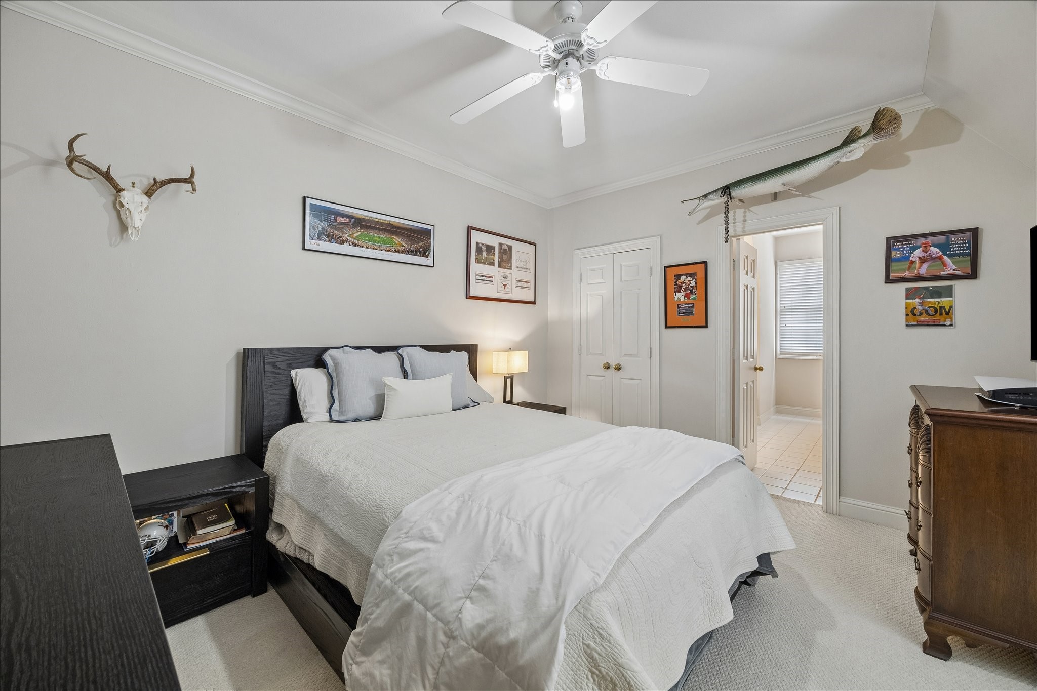 11421 Whippoorwill Road Houston, TX 77024 - Photo 17 of 33 This well-appointed secondary bedroom features soft neutral tones, carpeting, and crown molding. The spacious layout provides ample room for full-sized furniture and en-suite bathroom, making it a comfortable and private retreat for family members or guests.