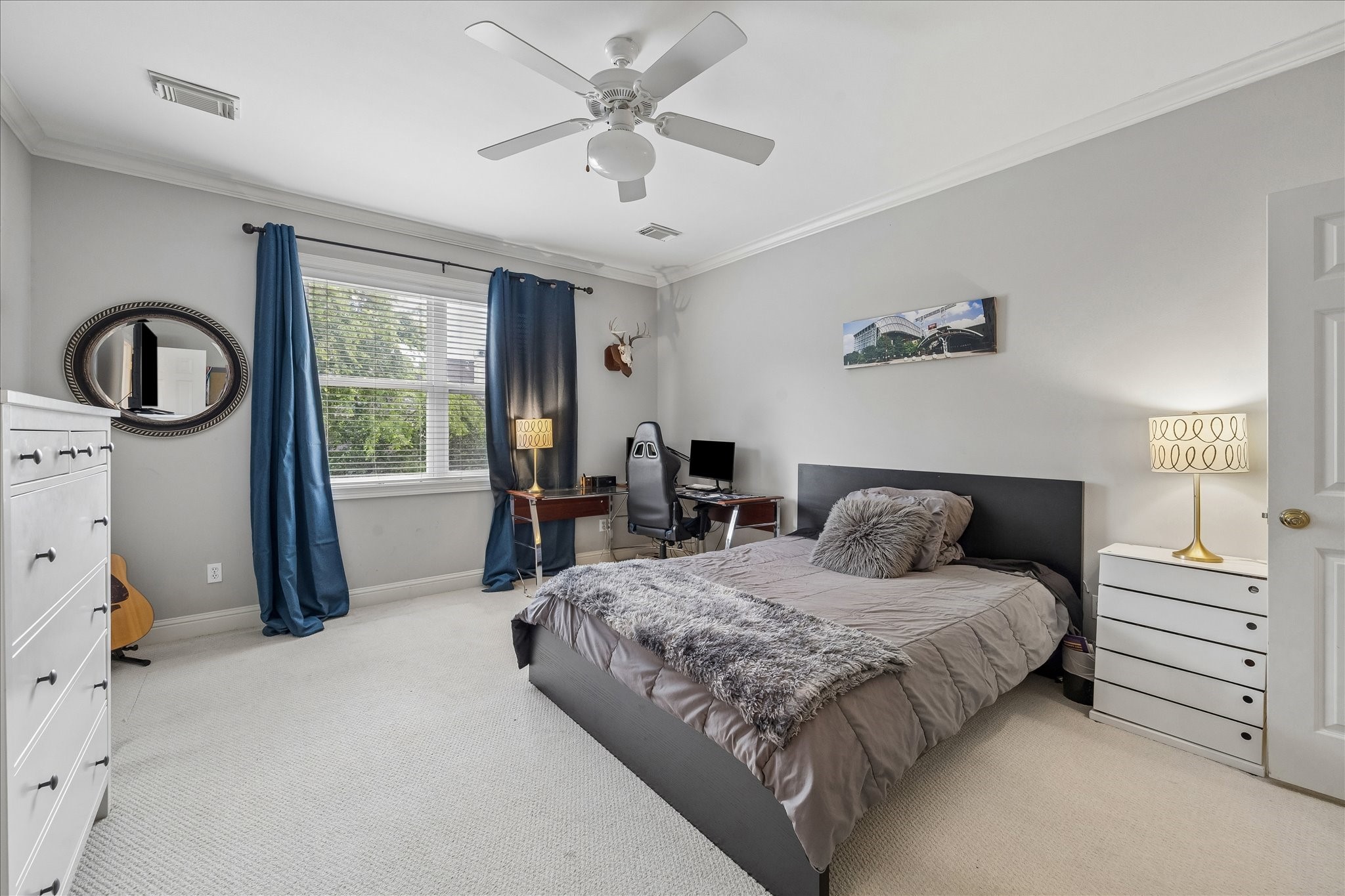 11421 Whippoorwill Road Houston, TX 77024 - Photo 19 of 33 Spacious upstairs bedroom featuring a private en-suite bath and large windows for plenty of natural light. Includes high ceilings, a ceiling fan, and a flexible layout perfect for a guest suite or kid retreat.