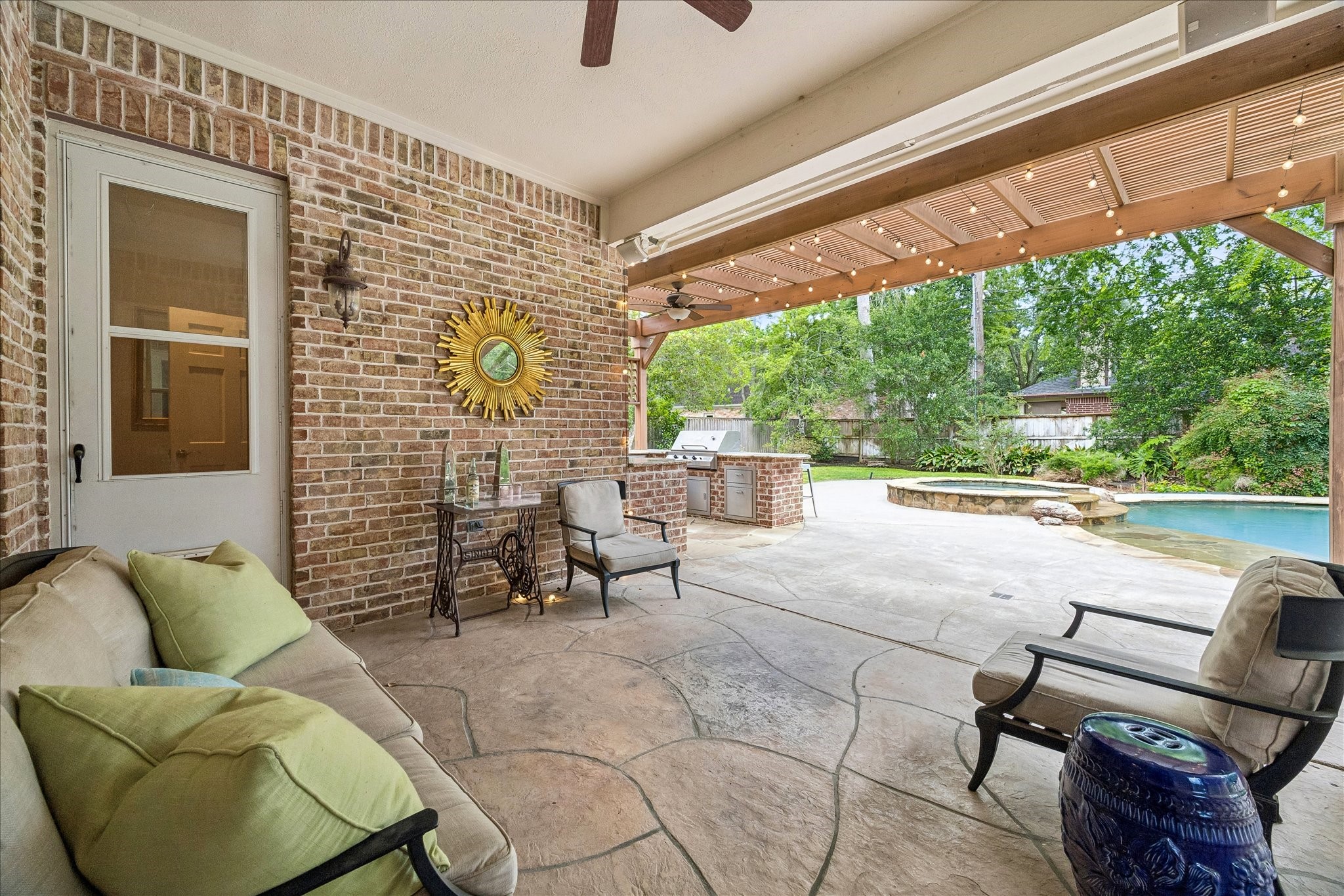 11421 Whippoorwill Road Houston, TX 77024 - Photo 25 of 33 Stunning summer kitchen and covered patio overlooking the backyard oasis. Features a built-in grill, granite countertops, and a spacious brick-accented lounge area. A true extension of the home, perfect for year-round outdoor entertaining.