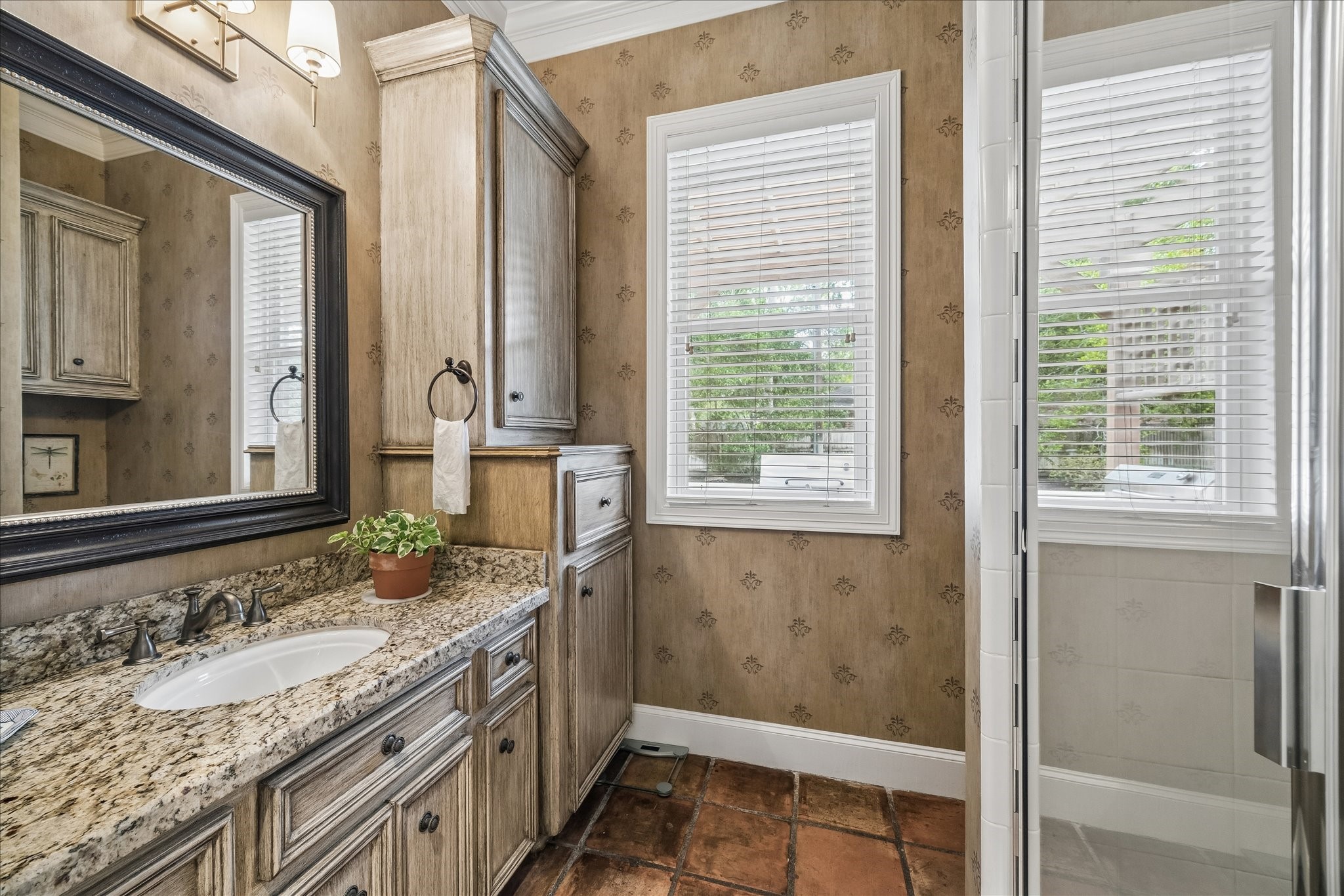 11421 Whippoorwill Road Houston, TX 77024 - Photo 29 of 33 he perfect downstairs pool bath! Located right off the back entrance and secondary staircase, this full bathroom offers a walk-in shower, granite vanity, and ample storage. A high-function feature that keeps the rest of the home dry and tidy.