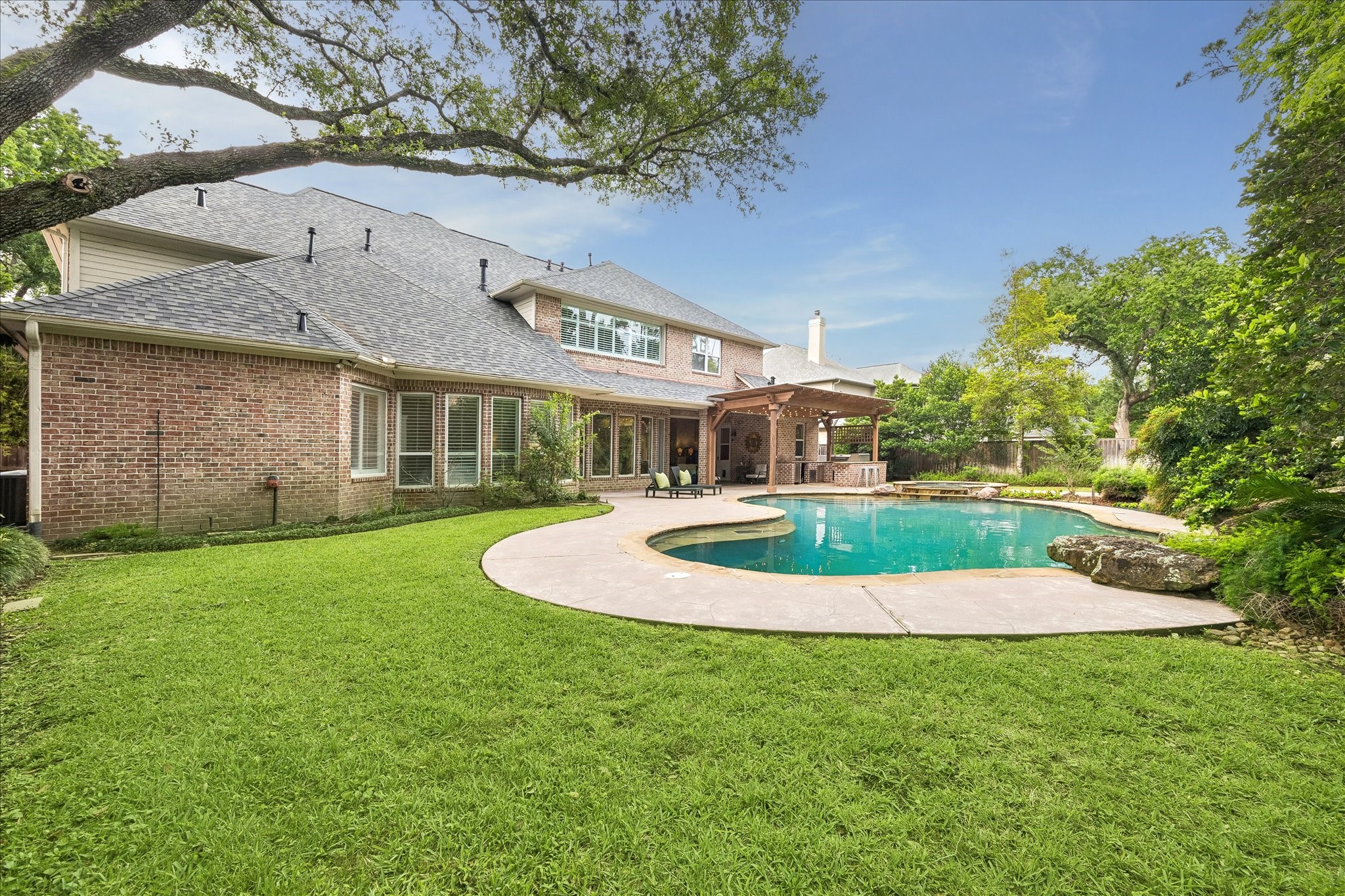 11421 Whippoorwill Road Houston, TX 77024 - Photo 33 of 33 Rare backyard retreat featuring a new roof (2024)* and a massive, private lot. This view highlights the expansive green space adjacent to the pool and outdoor living areas. A perfect combination of high-end upgrades and functional outdoor space.* As per seller.