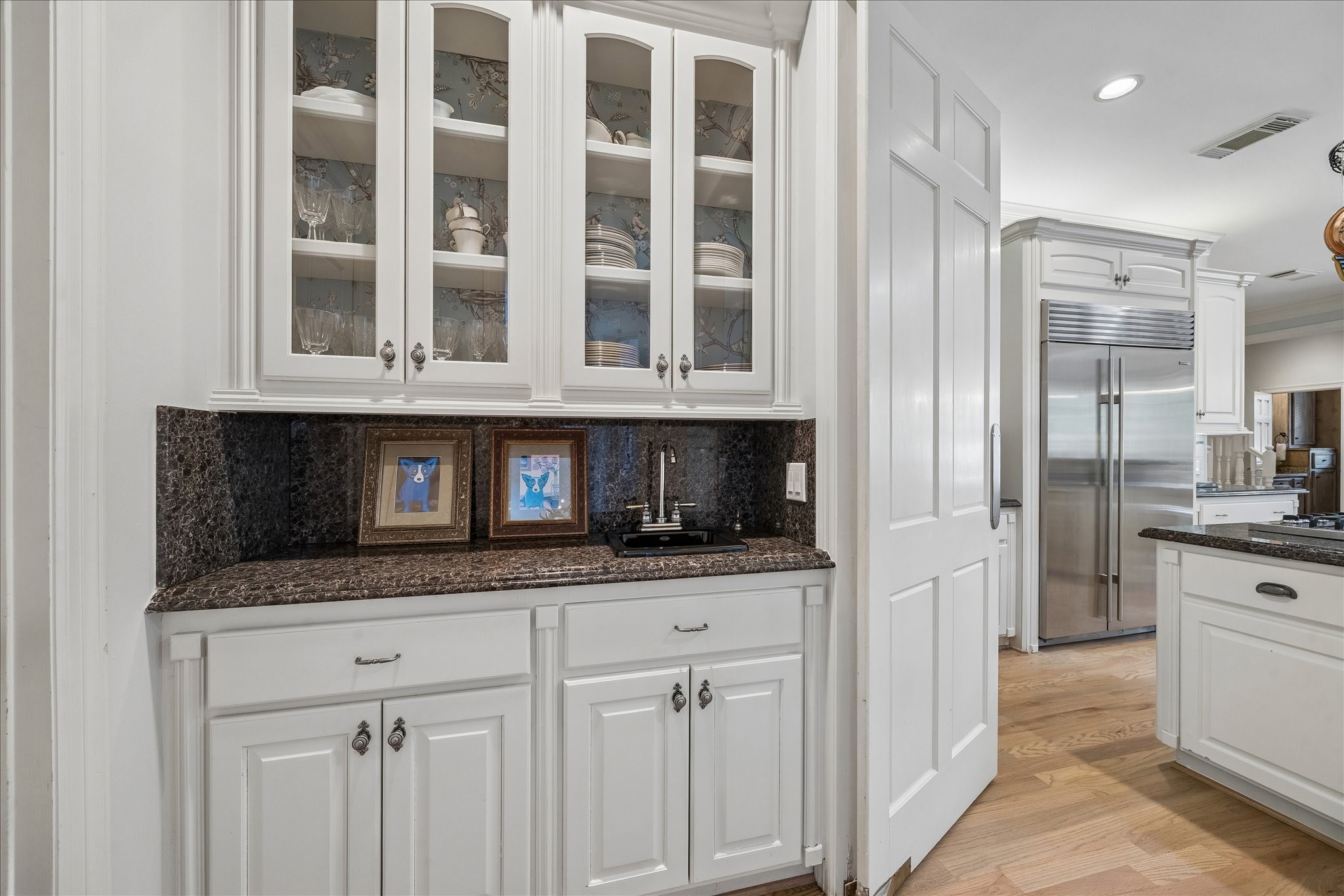 11421 Whippoorwill Road Houston, TX 77024 - Photo 8 of 33 Butler's pantry with granite countertops and backsplash,sink and built-in china cabinets.