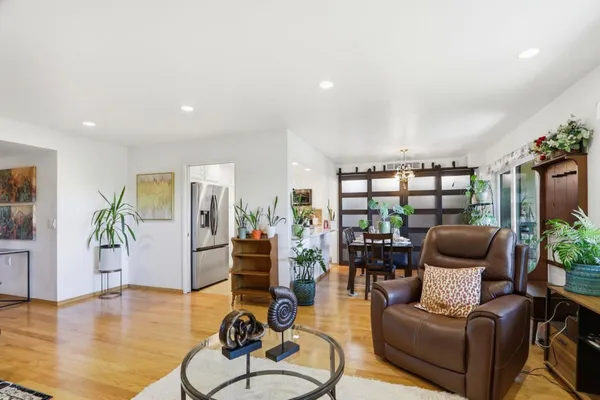 a living room with furniture and a wooden floor