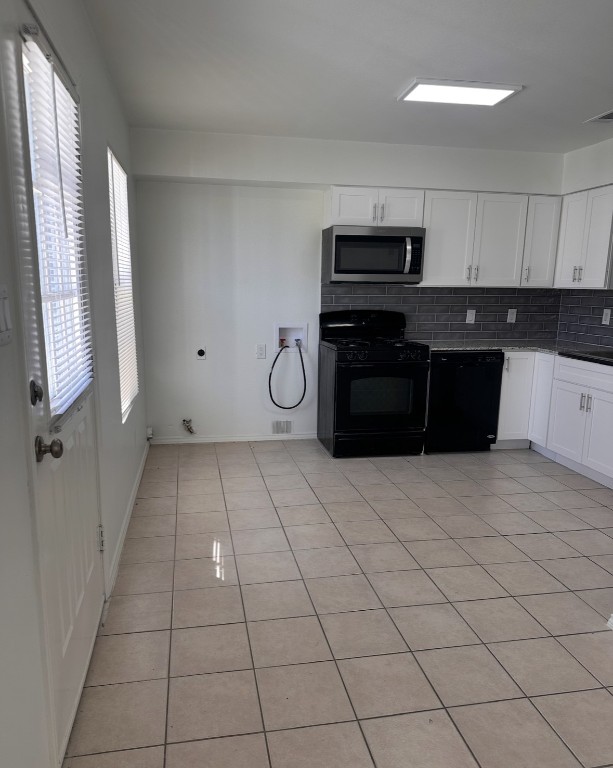 6910 Circle S Road, Unit B Austin, TX 78745 - Photo 4 of 10 a kitchen with a refrigerator and cabinets