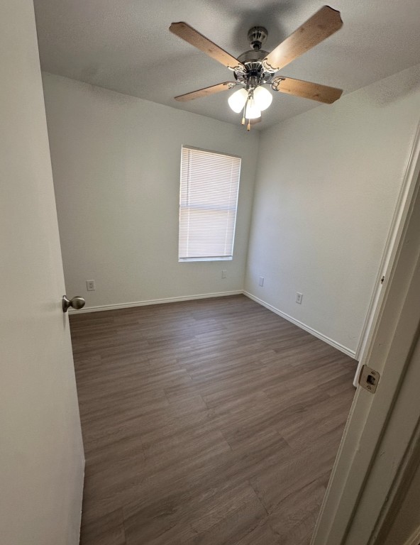 6910 Circle S Road, Unit B Austin, TX 78745 - Photo 7 of 10 wooden floor in an empty room with a window
