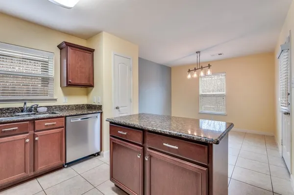 a kitchen with granite countertop cabinets stainless steel appliances a sink and a counter top space