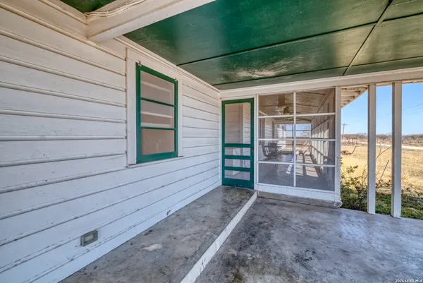a view of a house with a backyard and a tree