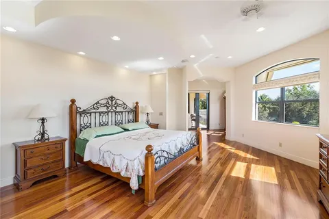 a bedroom with a bed and a large window