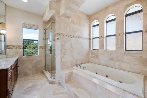 a bathroom with a bathtub and a shower