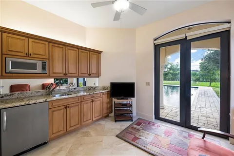 a kitchen with stainless steel appliances granite countertop a stove sink and cabinets