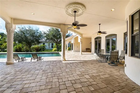 a view of a patio with a dining table and chairs