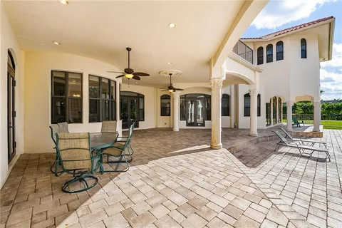 a patio with yard and outdoor seating
