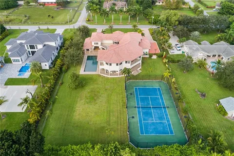 an aerial view of residential houses with outdoor space and street view