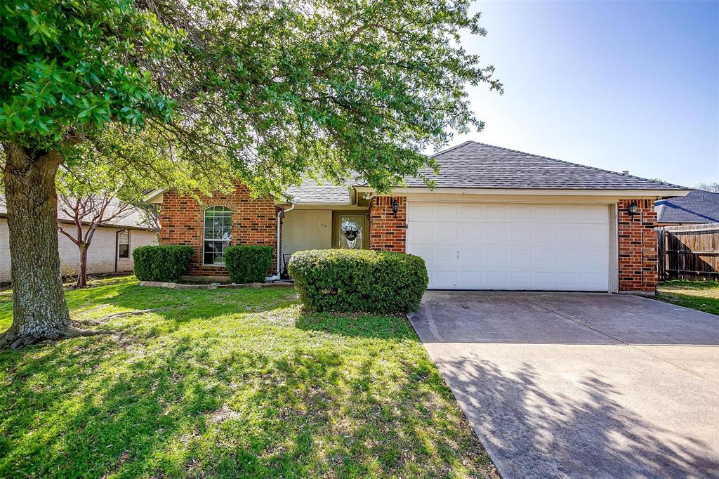 View of front of home with concrete driveway, brick siding, a front lawn, and an attached garage