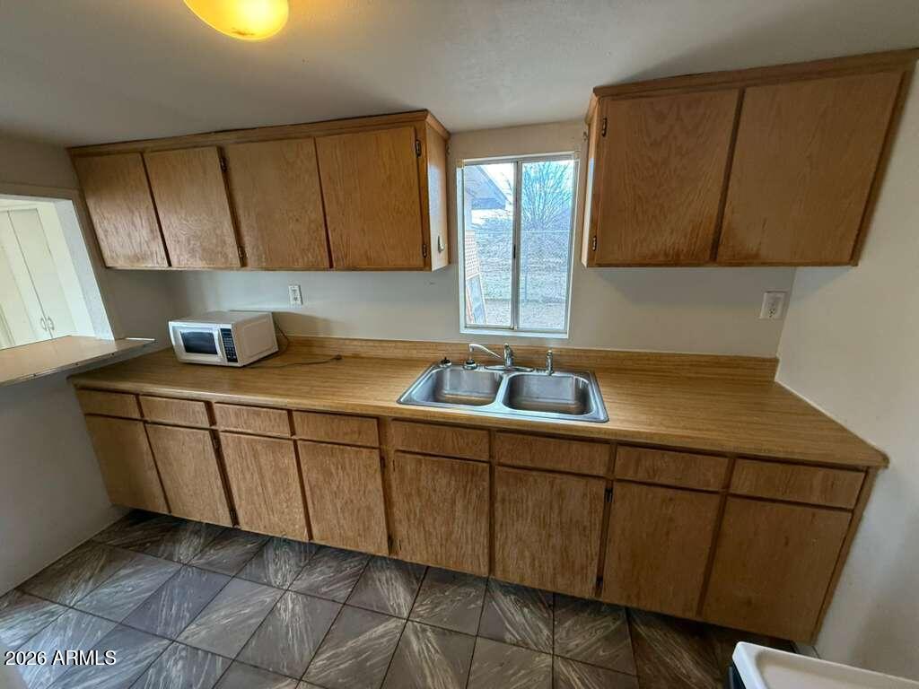 1365 East 20th Street Douglas, AZ 85607 - Photo 5 of 15 a kitchen with a sink and cabinets