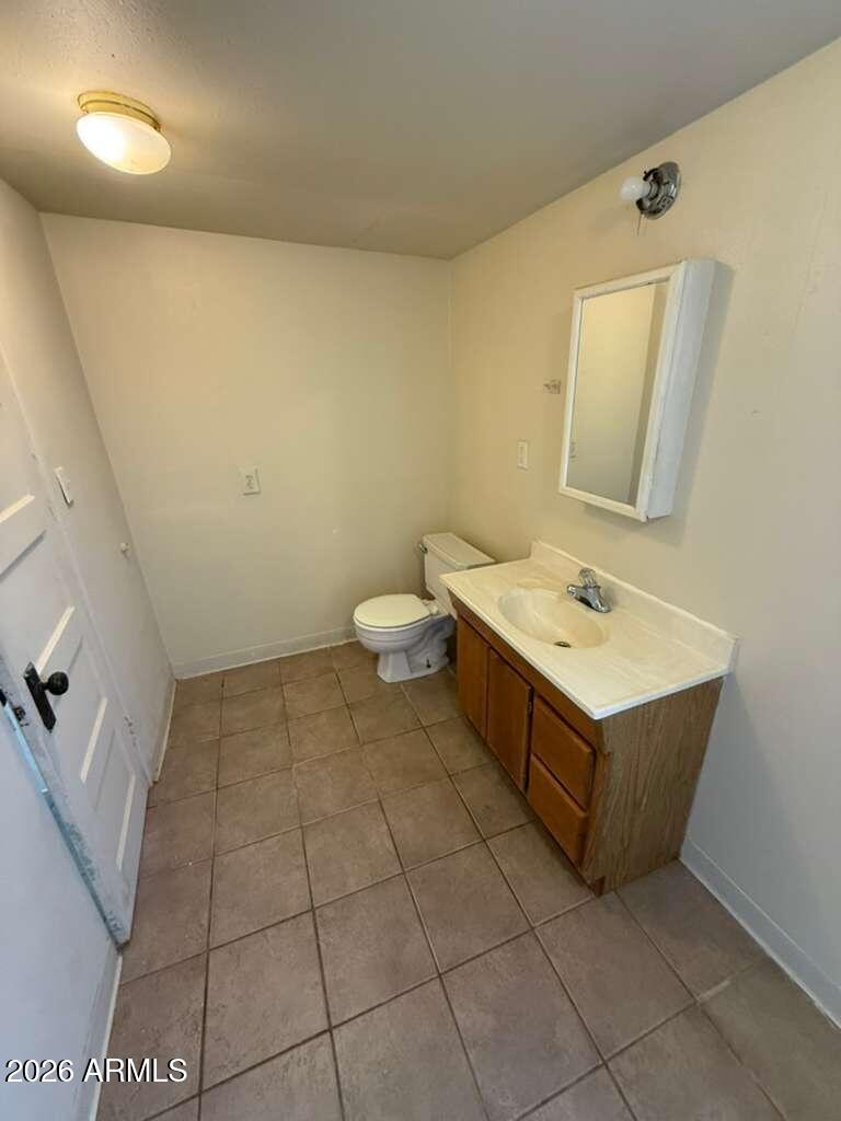 1365 East 20th Street Douglas, AZ 85607 - Photo 8 of 15 a bathroom with a sink toilet and mirror
