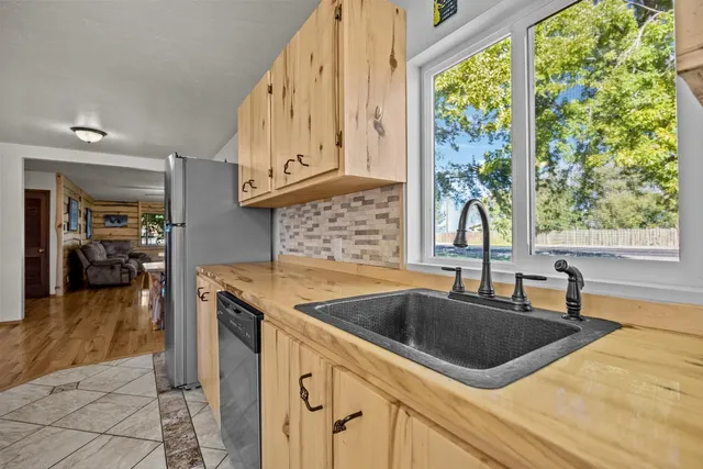 a kitchen that has a sink and a large window