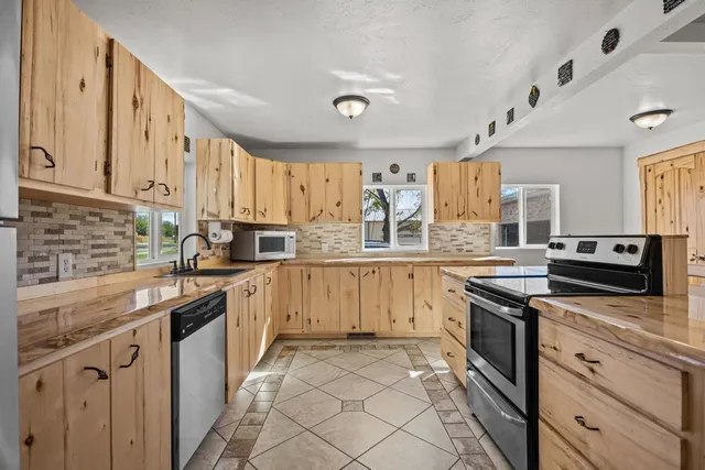 a kitchen with stainless steel appliances granite countertop a sink and cabinets