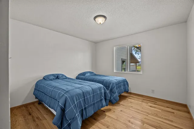 a bedroom with two beds and a wall painting