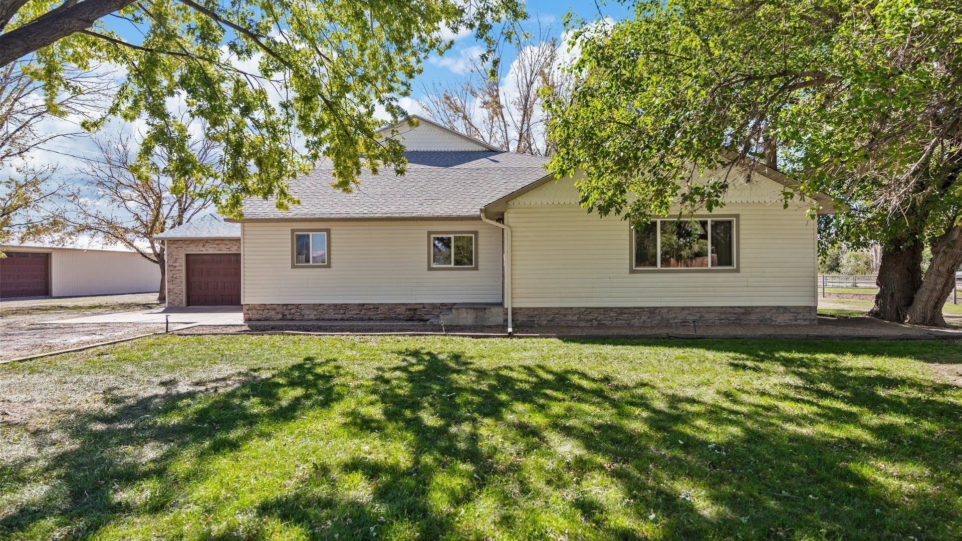 1903 J Road Fruita, CO 81521 - Photo 3 of 35 a house with a tree in front of it
