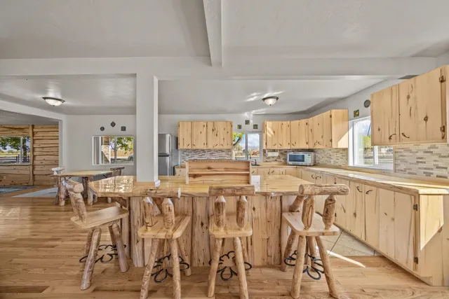 a kitchen with stainless steel appliances a table and chairs