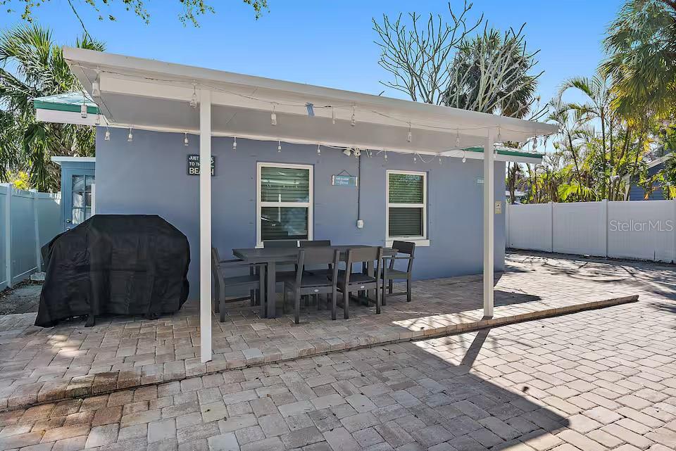 724 Gulf Boulevard Indian Rocks Beach, FL 33785 - Photo 12 of 55 a view of a patio with table and chairs with wooden floor and plants