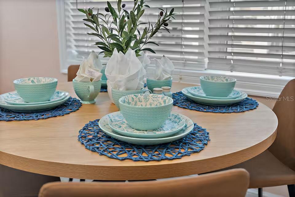 724 Gulf Boulevard Indian Rocks Beach, FL 33785 - Photo 20 of 55 a vase of flowers sitting on a dining table