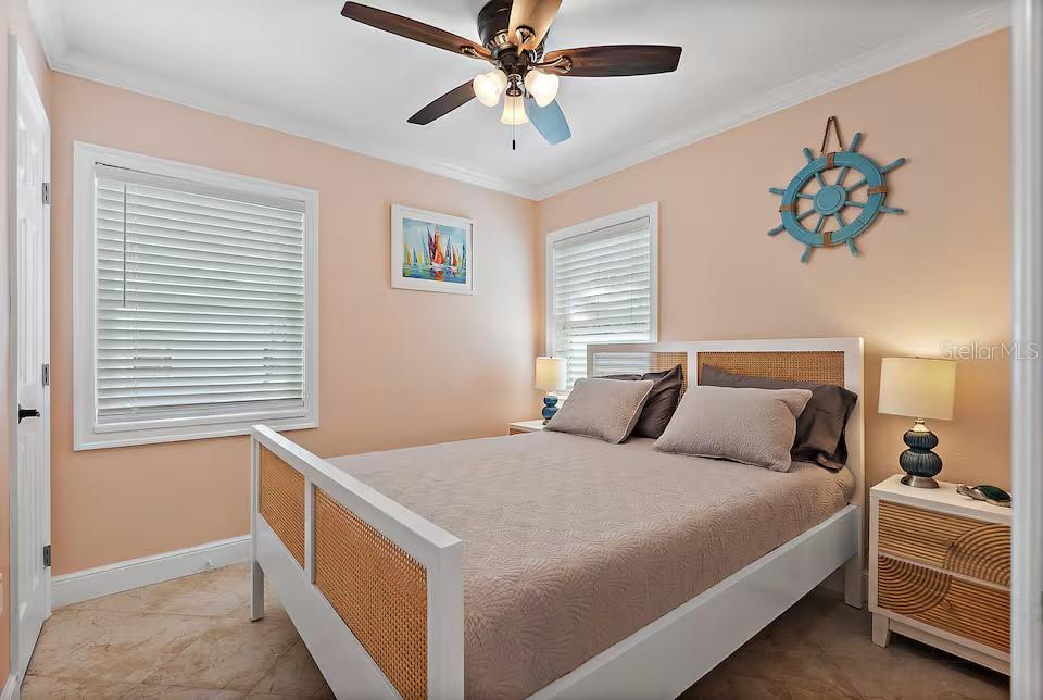 724 Gulf Boulevard Indian Rocks Beach, FL 33785 - Photo 21 of 55 a bedroom with a bed and a chandelier