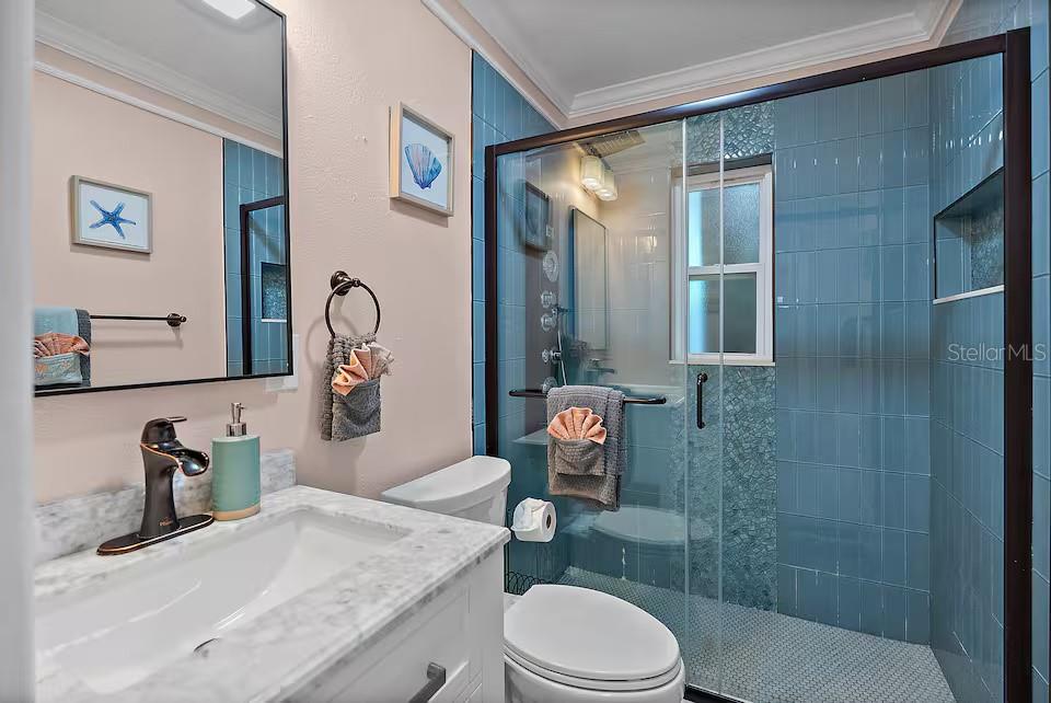 724 Gulf Boulevard Indian Rocks Beach, FL 33785 - Photo 23 of 55 a bathroom with a granite countertop sink toilet and shower
