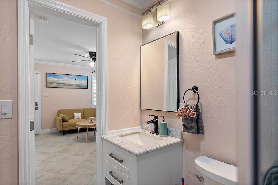 724 Gulf Boulevard Indian Rocks Beach, FL 33785 - Photo 24 of 55 a en suite bathroom with a toilet sink and mirror