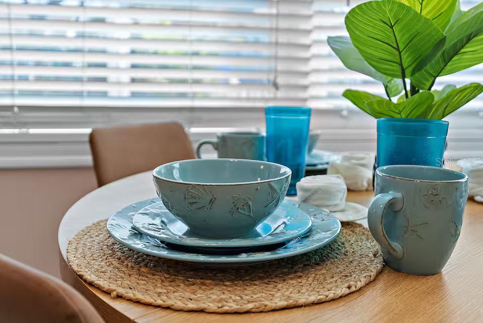 724 Gulf Boulevard Indian Rocks Beach, FL 33785 - Photo 32 of 55 a view of a vase of flowers sitting on a dining table