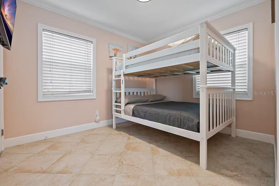 724 Gulf Boulevard Indian Rocks Beach, FL 33785 - Photo 34 of 55 a bedroom with a bed and a window