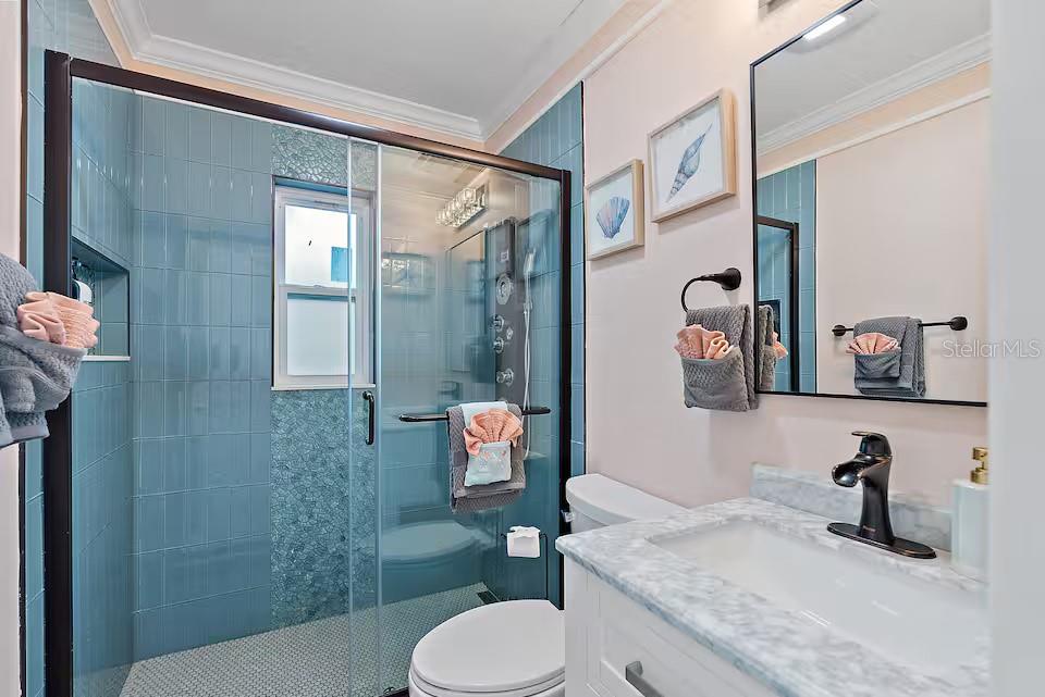 724 Gulf Boulevard Indian Rocks Beach, FL 33785 - Photo 35 of 55 a bathroom with a granite countertop sink mirror vanity and toilet