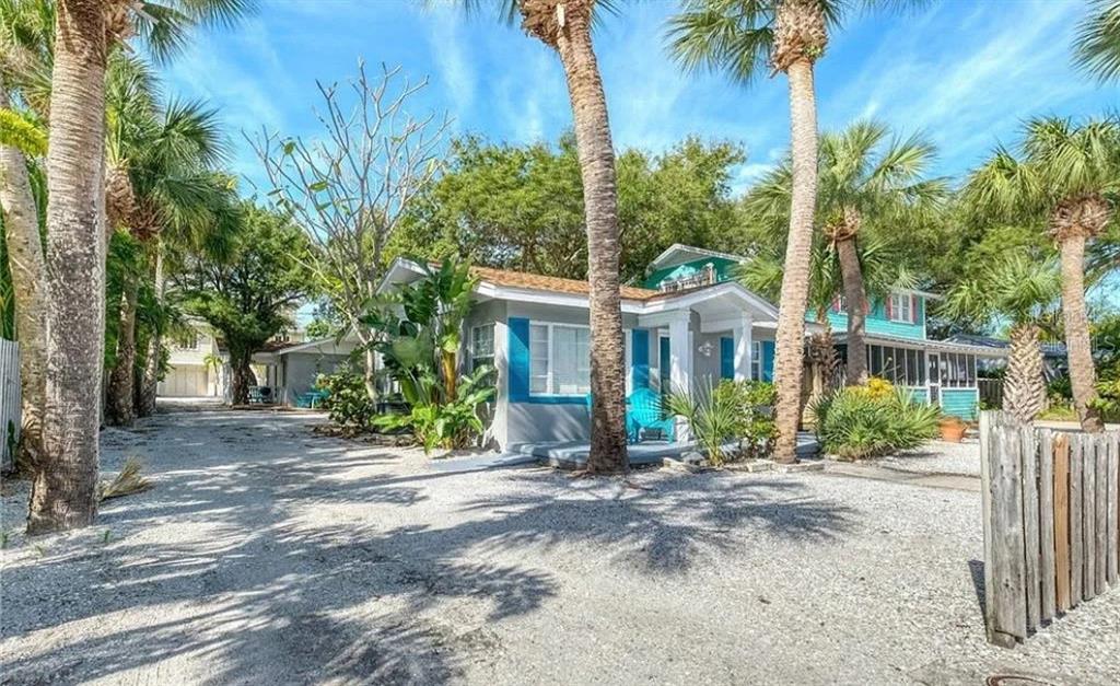 724 Gulf Boulevard Indian Rocks Beach, FL 33785 - Photo 9 of 55 a front view of a house with a yard and potted plants