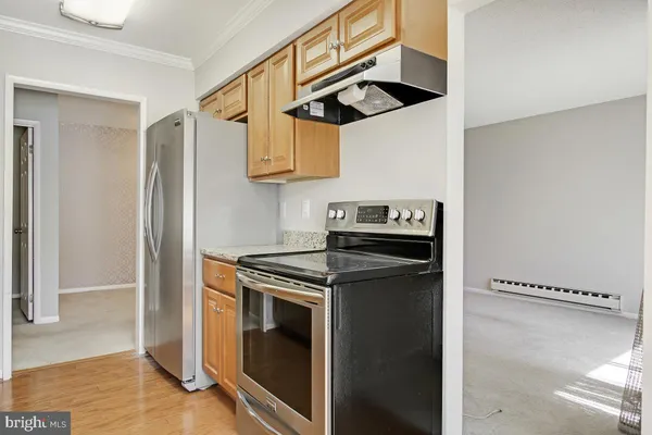 a kitchen with stainless steel appliances granite countertop a stove and a refrigerator