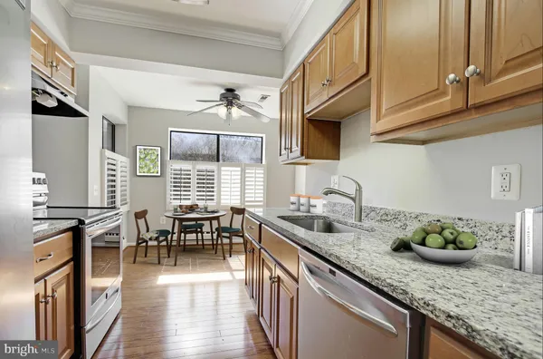 a kitchen with granite countertop lots of counter top space and living room