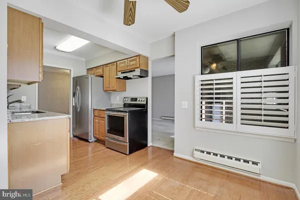 a kitchen with stainless steel appliances kitchen island granite countertop a stove and a microwave