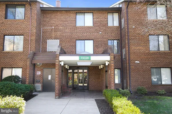 a front view of a brick building with many windows