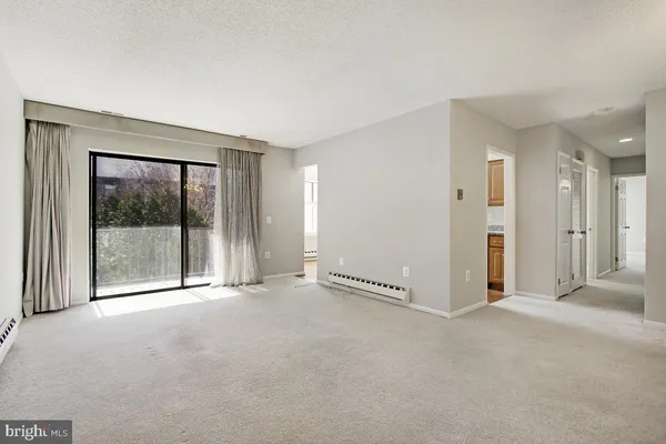 a view of an empty room with a sliding door