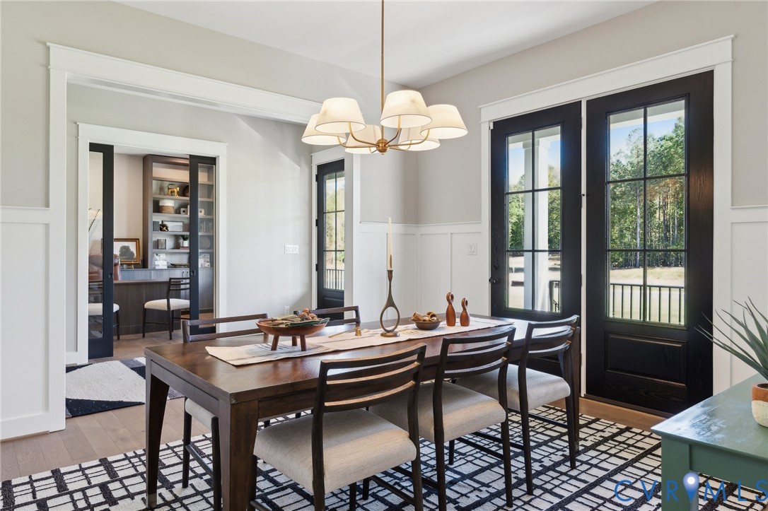 4976 Gooden Trail Quinton, VA 23141 - Photo 17 of 49 a view of a dining room with furniture a chandelier and wooden floor