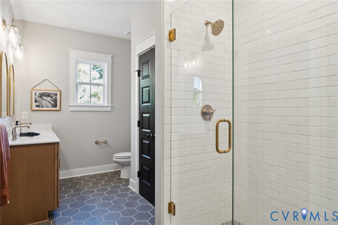 4976 Gooden Trail Quinton, VA 23141 - Photo 39 of 49 a bathroom with a granite countertop shower a toilet and a sink