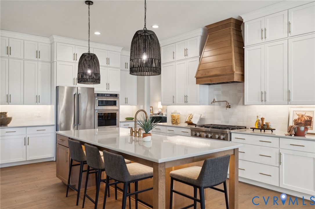 4976 Gooden Trail Quinton, VA 23141 - Photo 9 of 49 a kitchen with stainless steel appliances a sink a stove and chairs