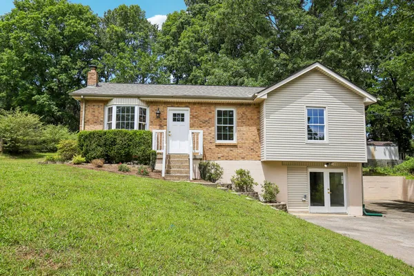 a front view of house with yard and green space